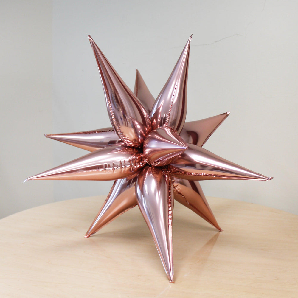 
                  
                    Ellie's Chrome Rose Gold Starburst Cluster Balloon (26 Inches) | Amazing Pinatas 
                  
                